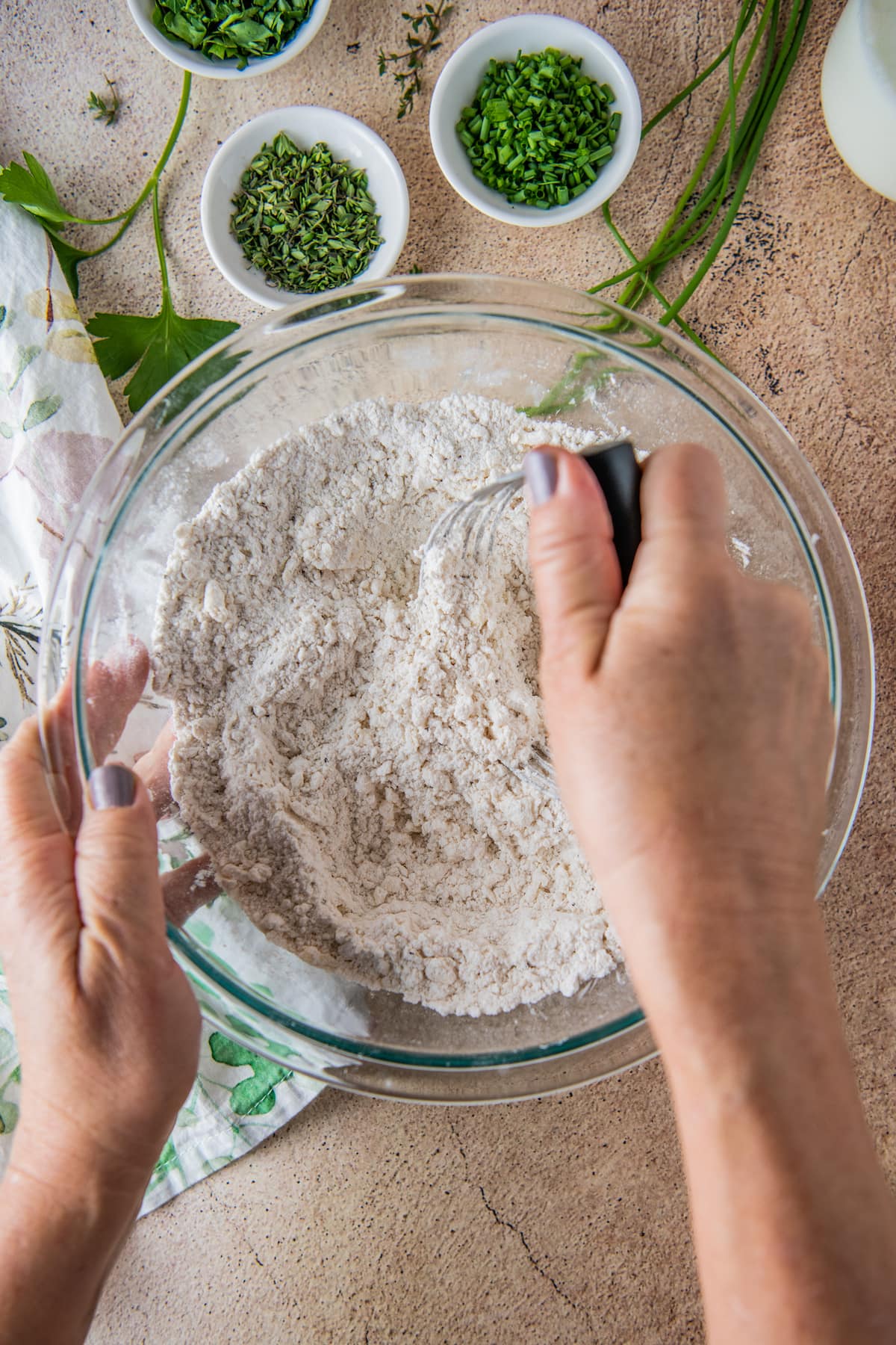 whisking together a flour mixture in a glass bowl