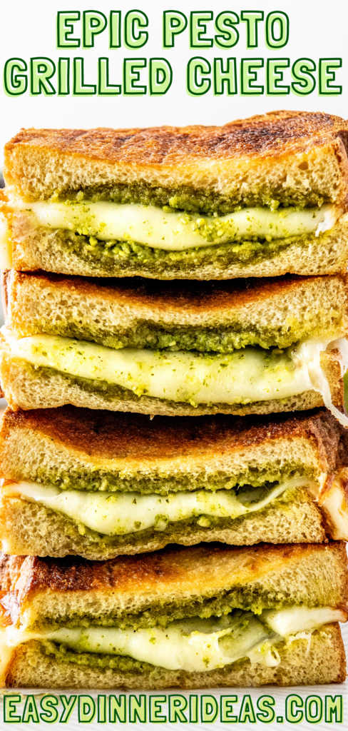 Pesto grilled cheese sandwiches cut in half and stacked on top of each other.