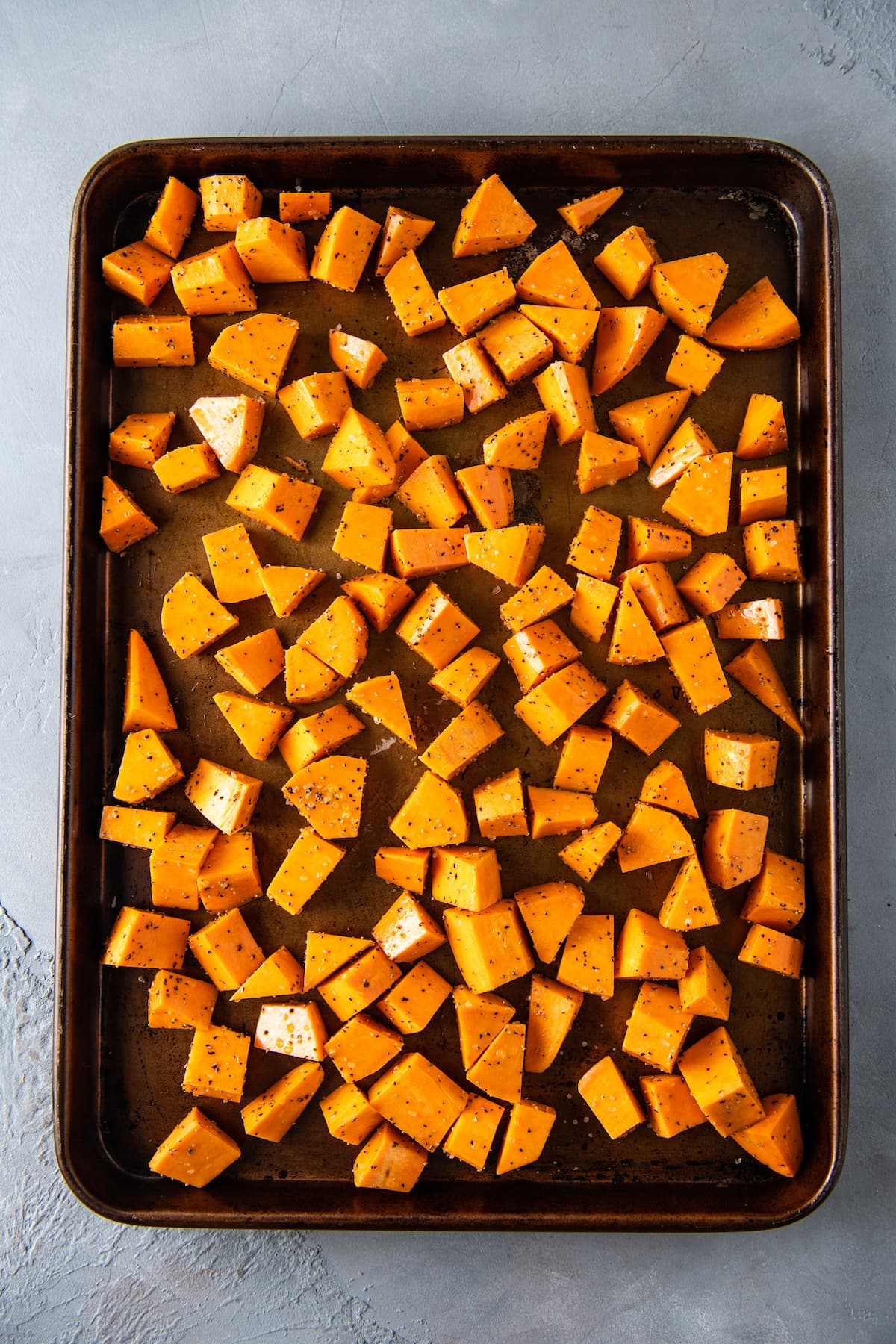 cut up sweet potatoes on a sheet tray