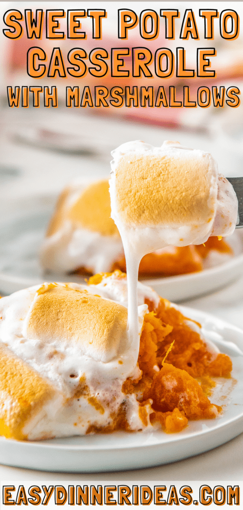 A fork picking up a bite of sweet potato casserole with marshmallows.