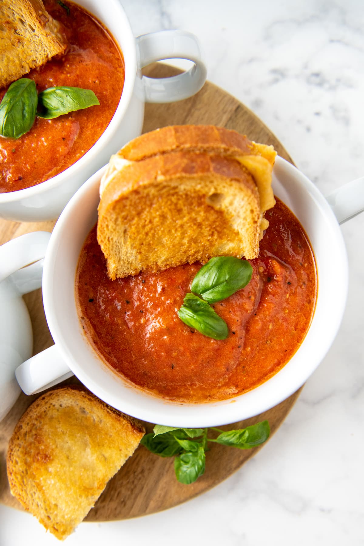 tomato basil soup with grilled cheese in the bowl