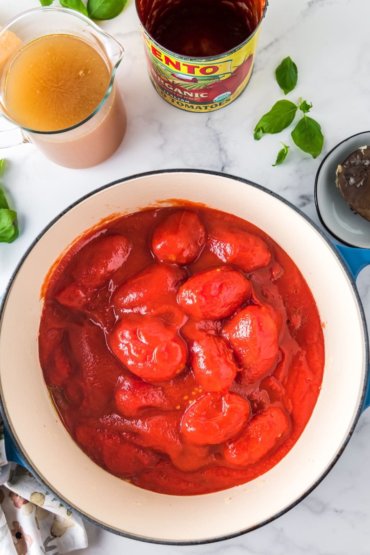 canned tomatoes in a large dutch oven