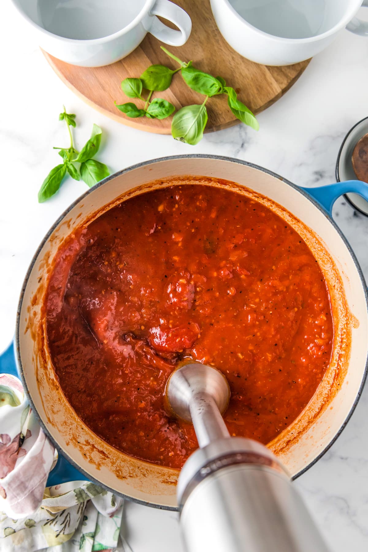 pureeing tomatoes in a large dutch oven