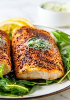 air fryer mahi mahi with seasoning and herb butter on a bed of lettuce