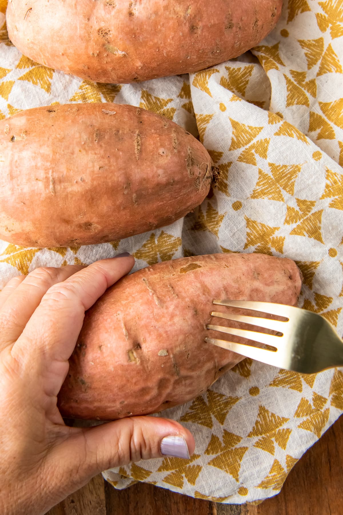 piercing sweet potatoes with a fork