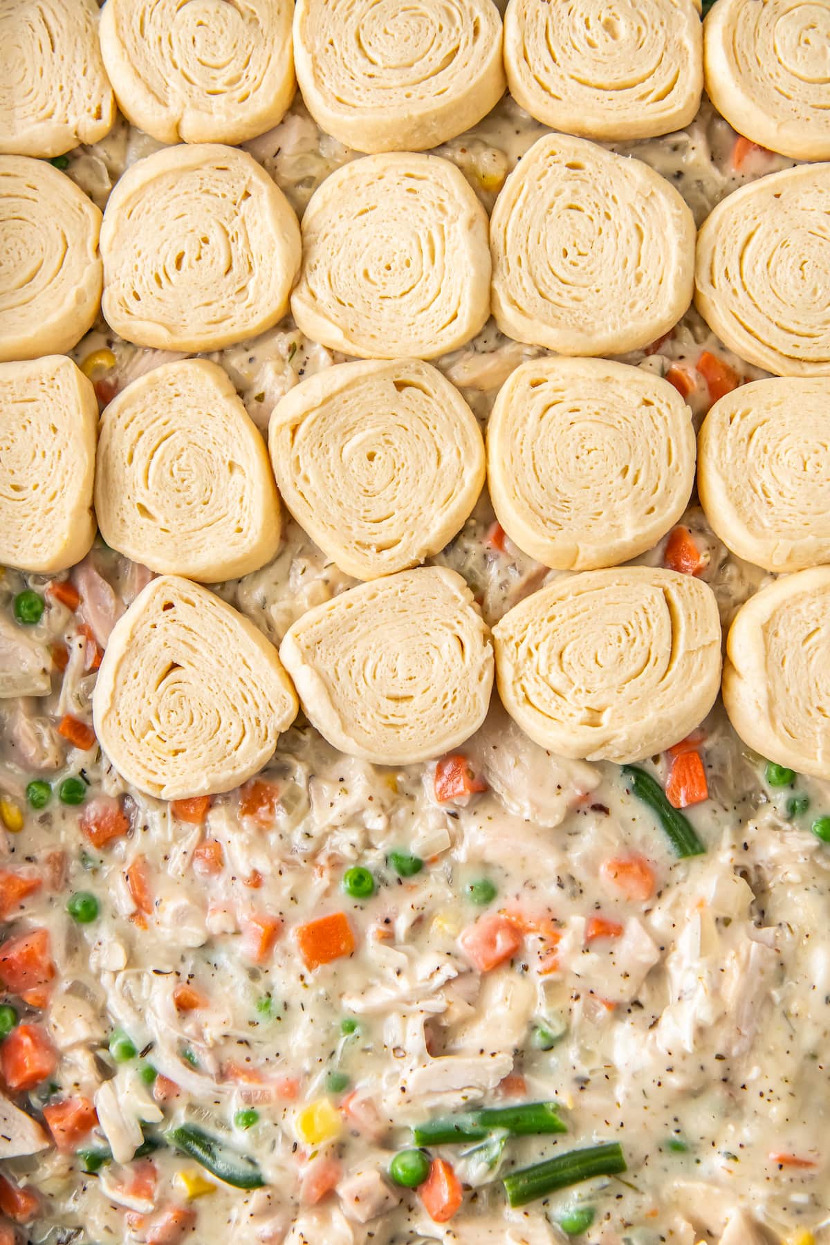 layering crescent rolls on top of chicken pot pie filling