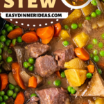Beef stew in a crockpot with a wooden spoon.