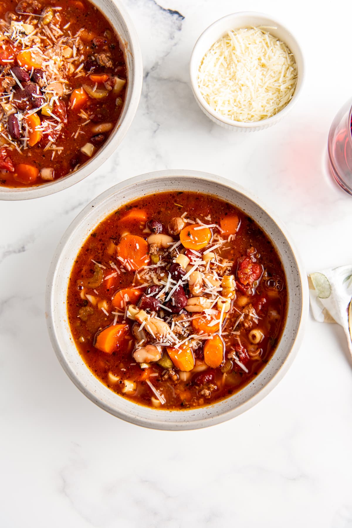 a bowl of fagioli soup with noodles, beef, and vegetables