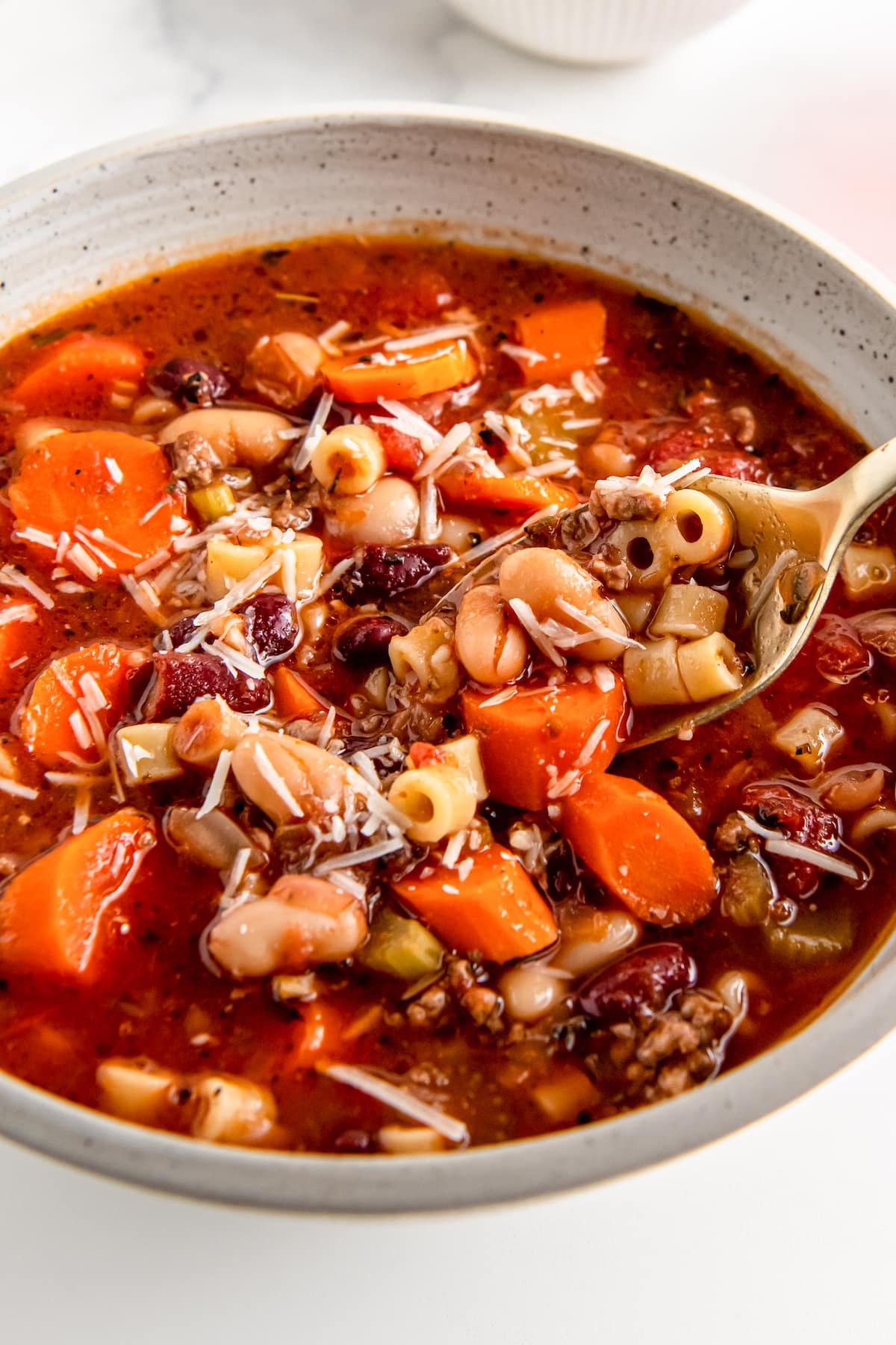 a bowl of fagioli soup with noodles, beef, and vegetables