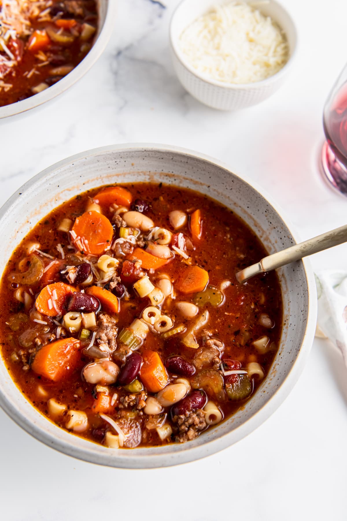 a bowl of fagioli soup with noodles, beef, and vegetables