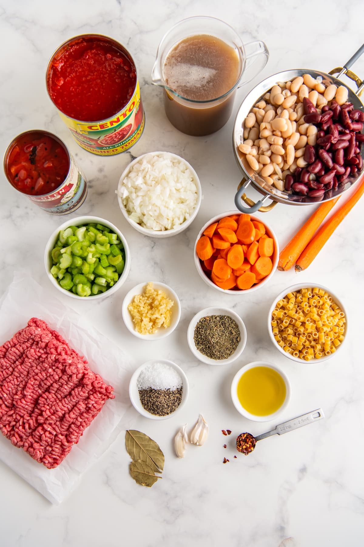 the ingredients to make fagioli noodle soup like chopped vegetabes, ground beef, and beans