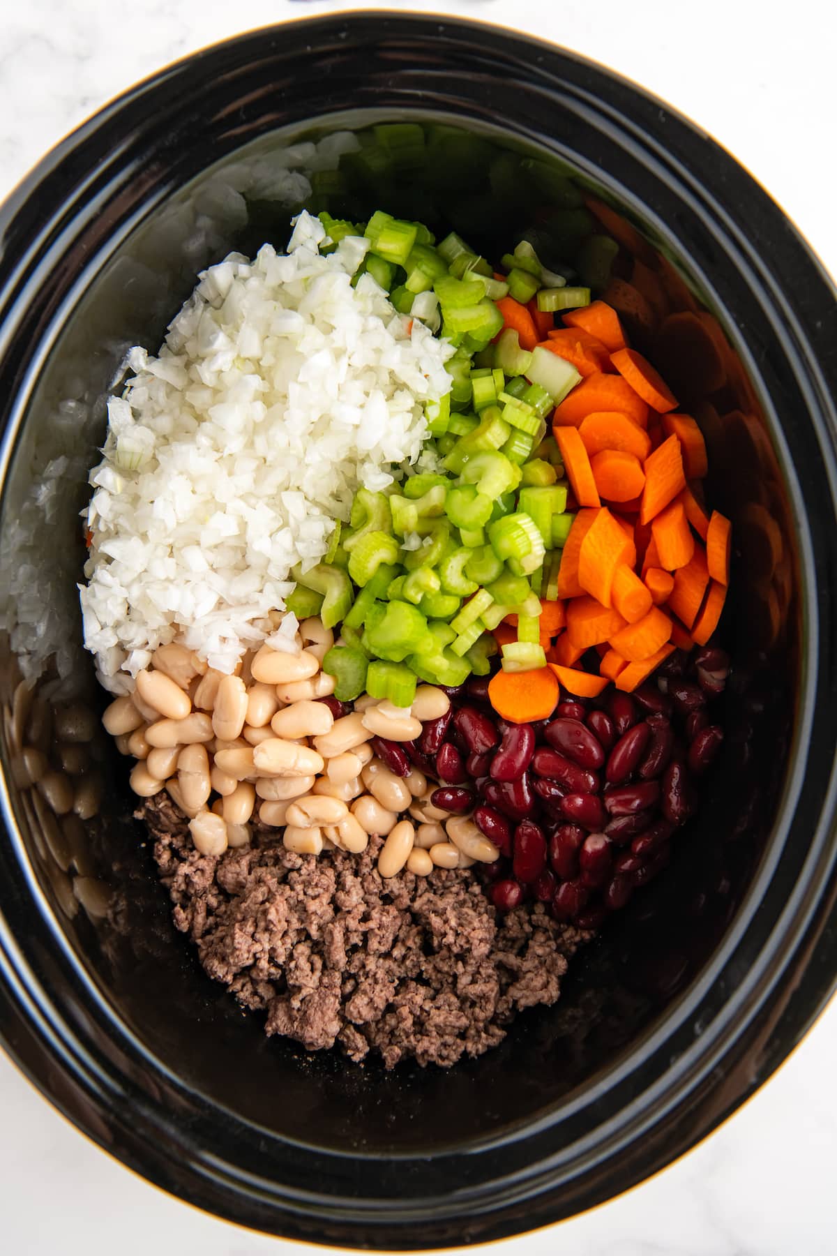 chopped vegetables, beans, and ground beef in a crockpot