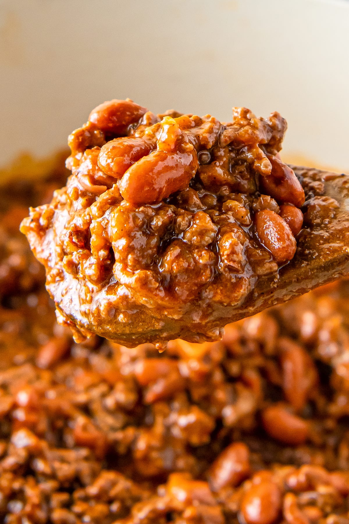 a wooden spoon with chili on it