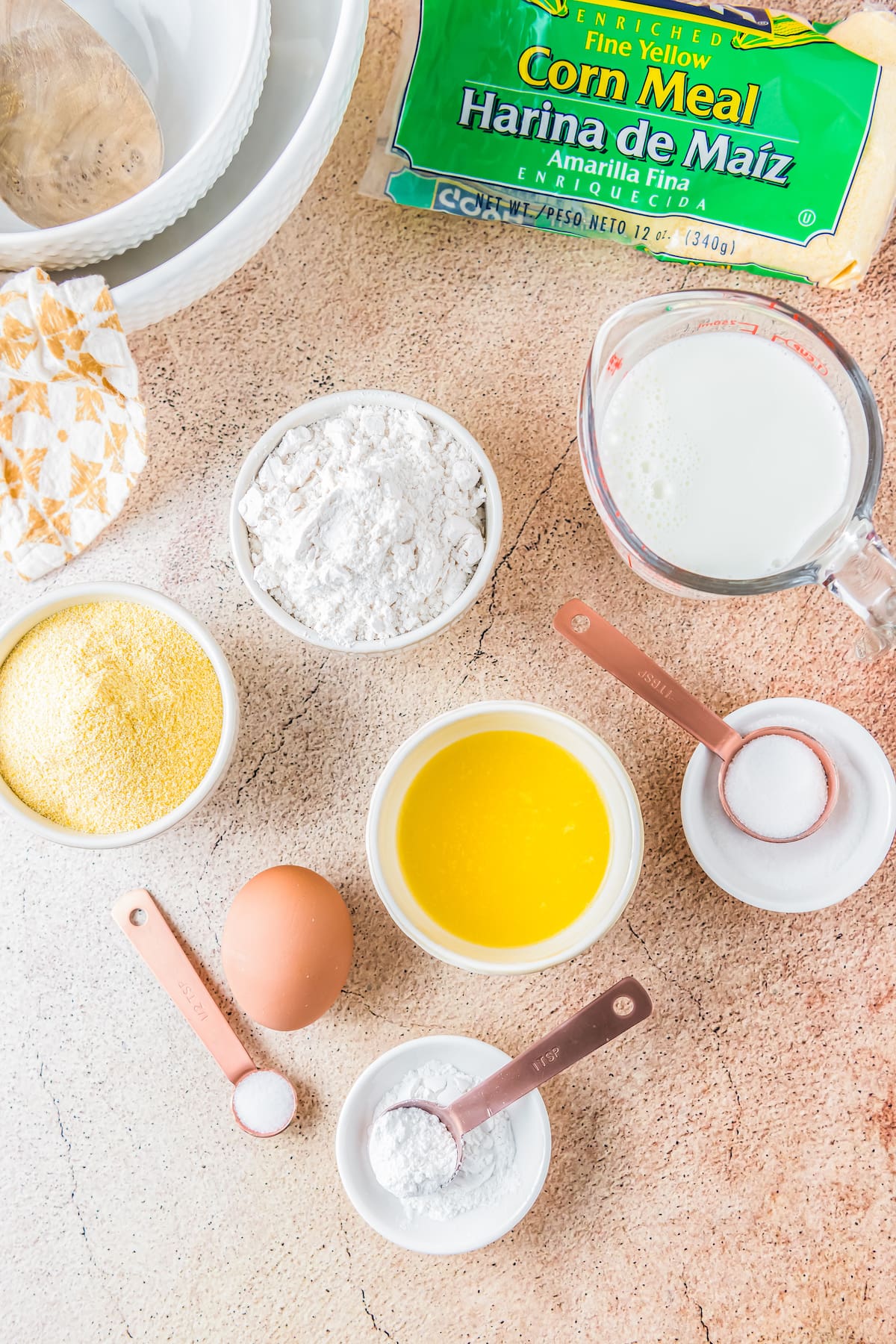 the ingredients to make classic cornbread like butter, flour, milk, cornmeal, and eggs