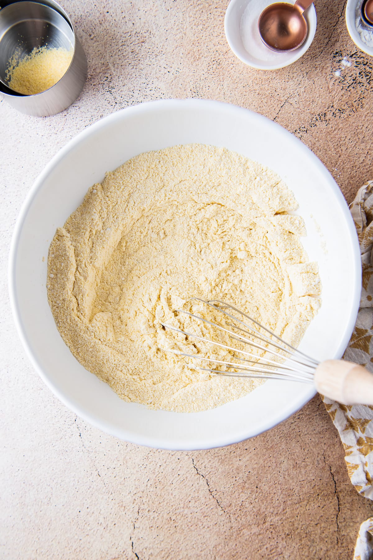 sifting dry ingredients with a whisk in a mixing bowl