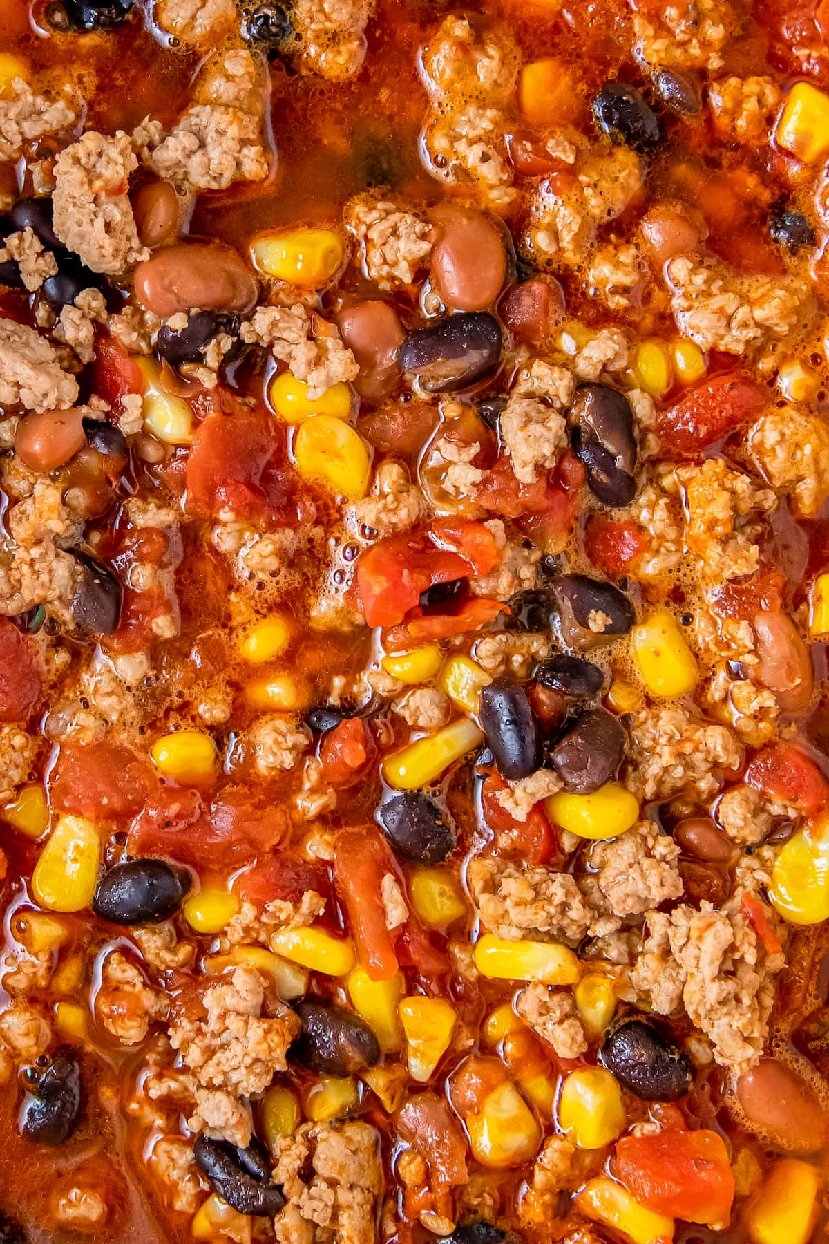 Taco soup made with beans, tomatoes, and corn in a tomato broth