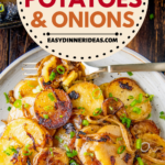 Fried potatoes and onions on a plate topped with green onions on top.
