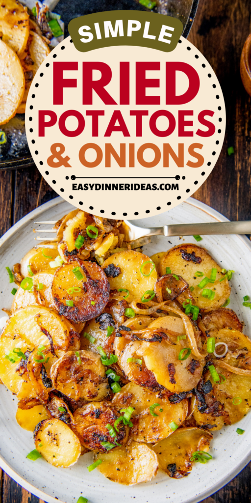 Fried potatoes and onions on a plate topped with green onions on top.