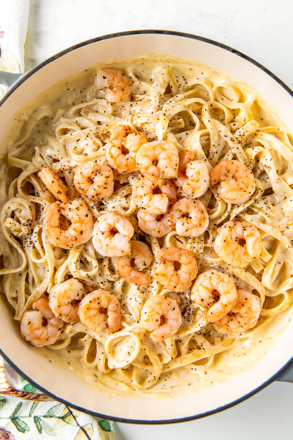 cooked shrimp on top of noodles in a pot