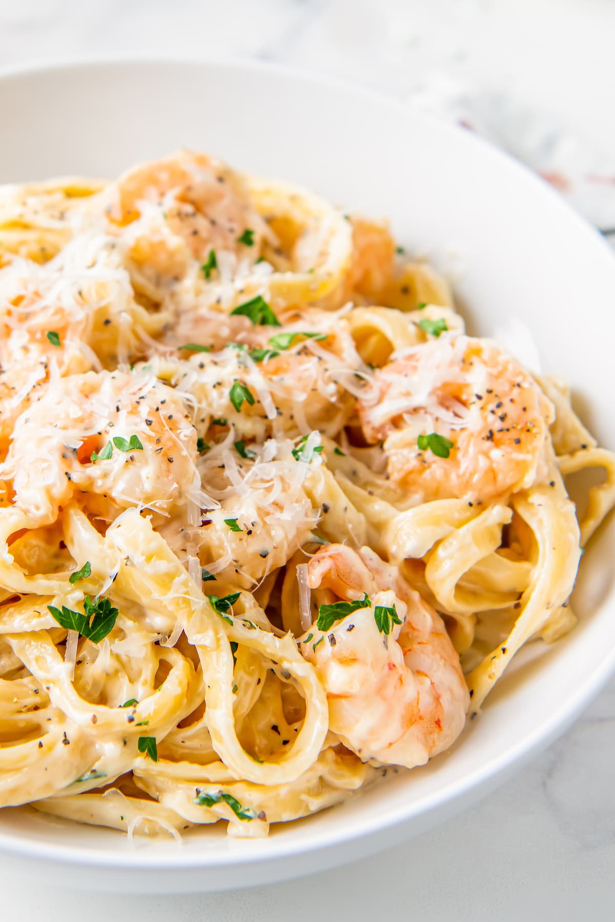 close up of shrimp alfredo on a plate