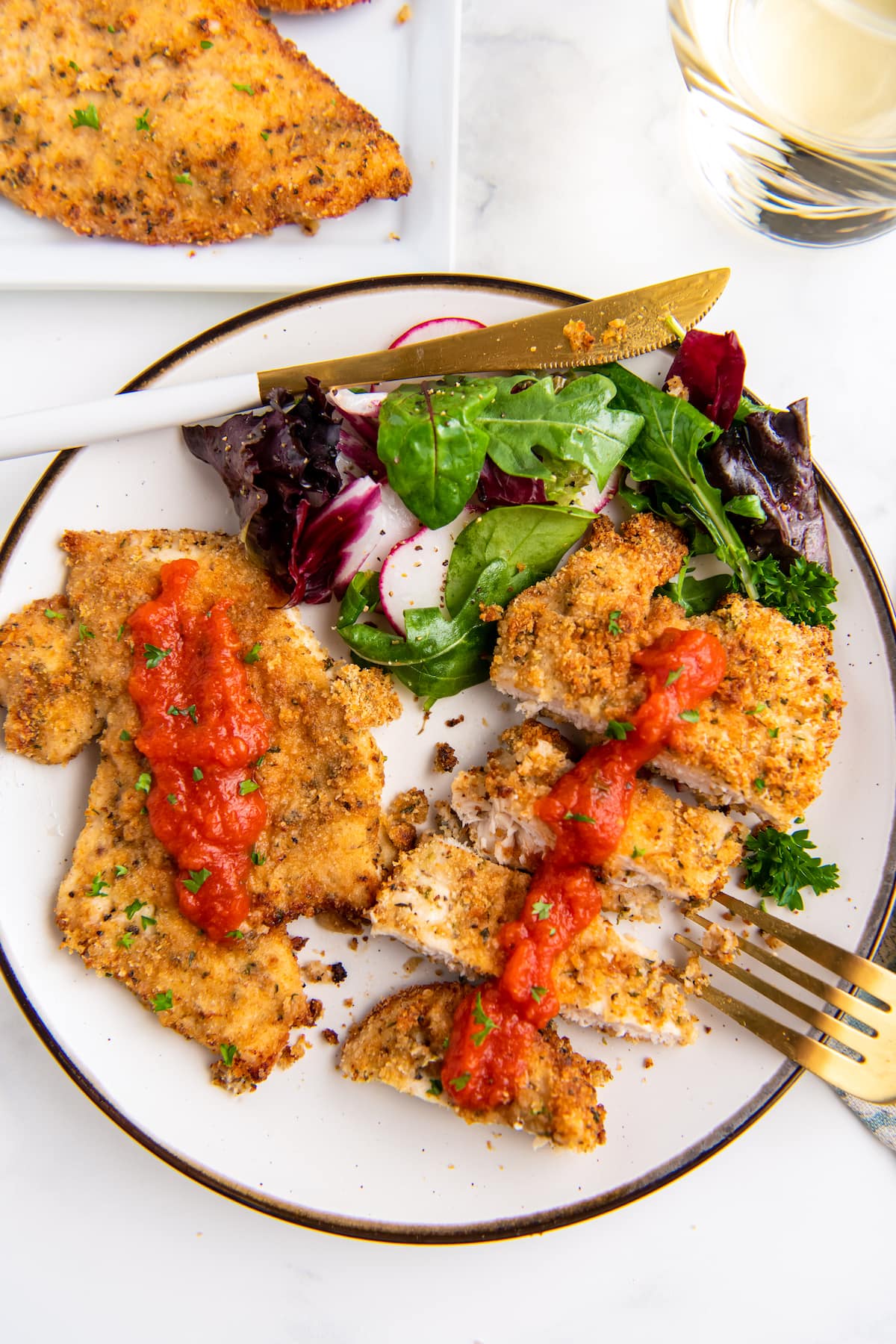 dinner plate with chicken cutlets and green salad