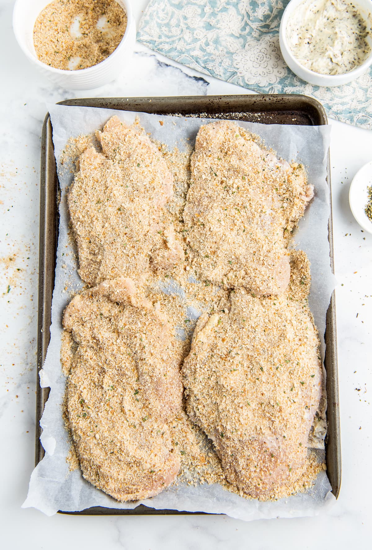 breaded chicken pieces on a sheet tray