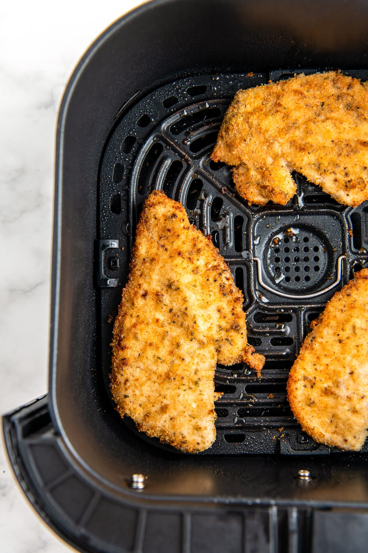 air fryer chicken cutlets in the air fryer tray