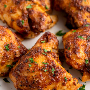 seasoned and cooked chicken thighs garnished with fresh herbs