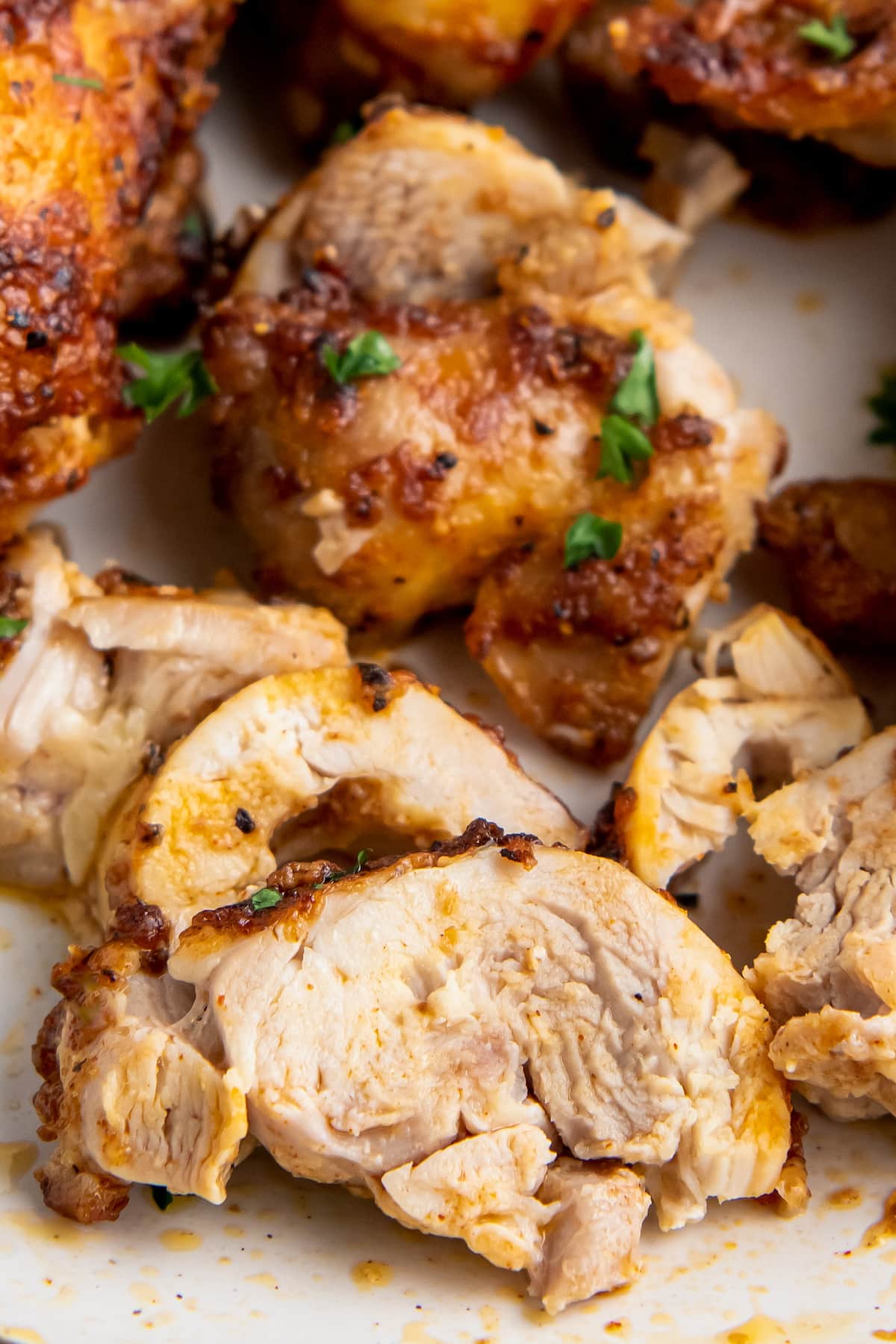 sliced air fryer chicken thighs on a plate