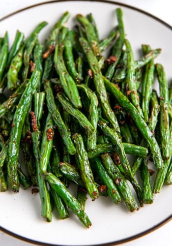 close up of air fryer green beans on a white plate.