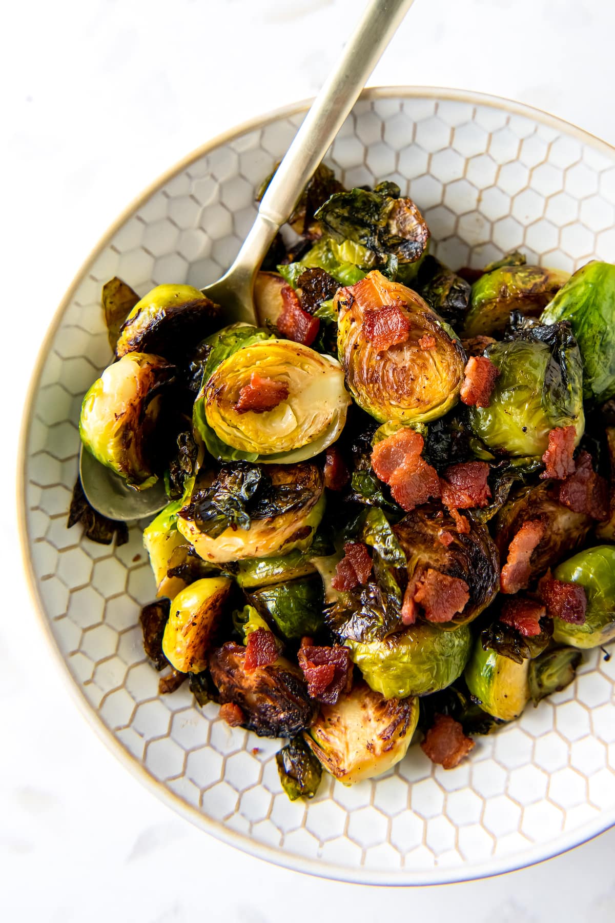 a plate of cooked brussels sprouts and bacon