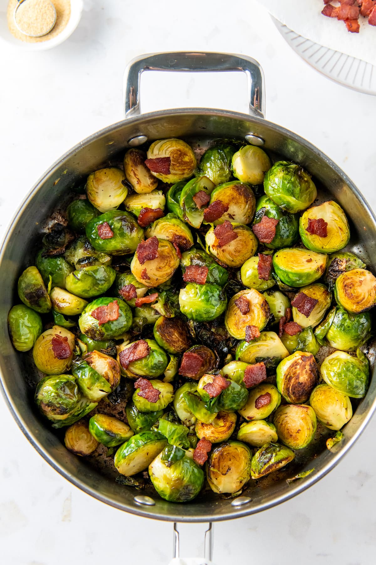 a pan of brussels sprouts and bites of bacon