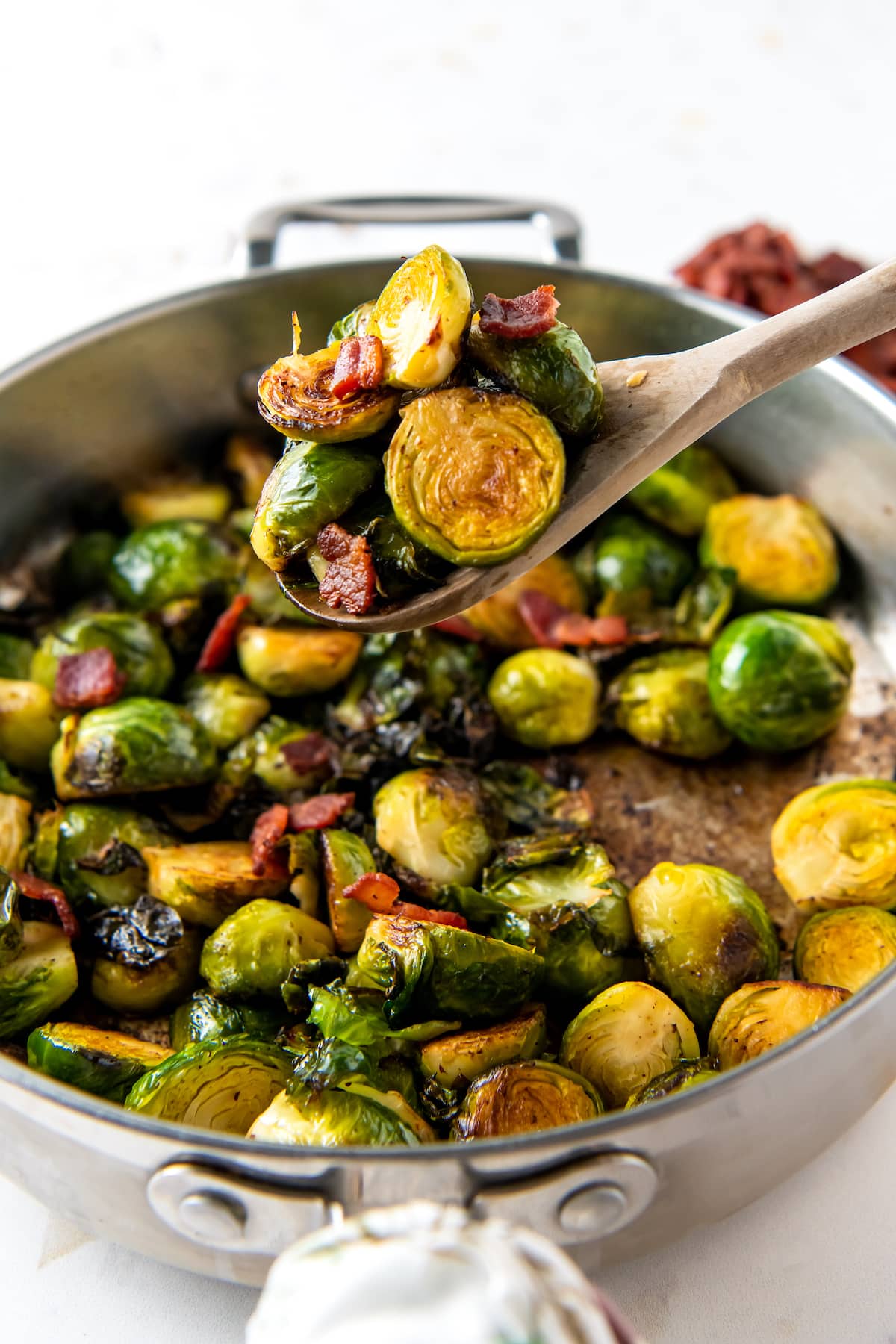 a pan of brussels sprouts and bites of bacon