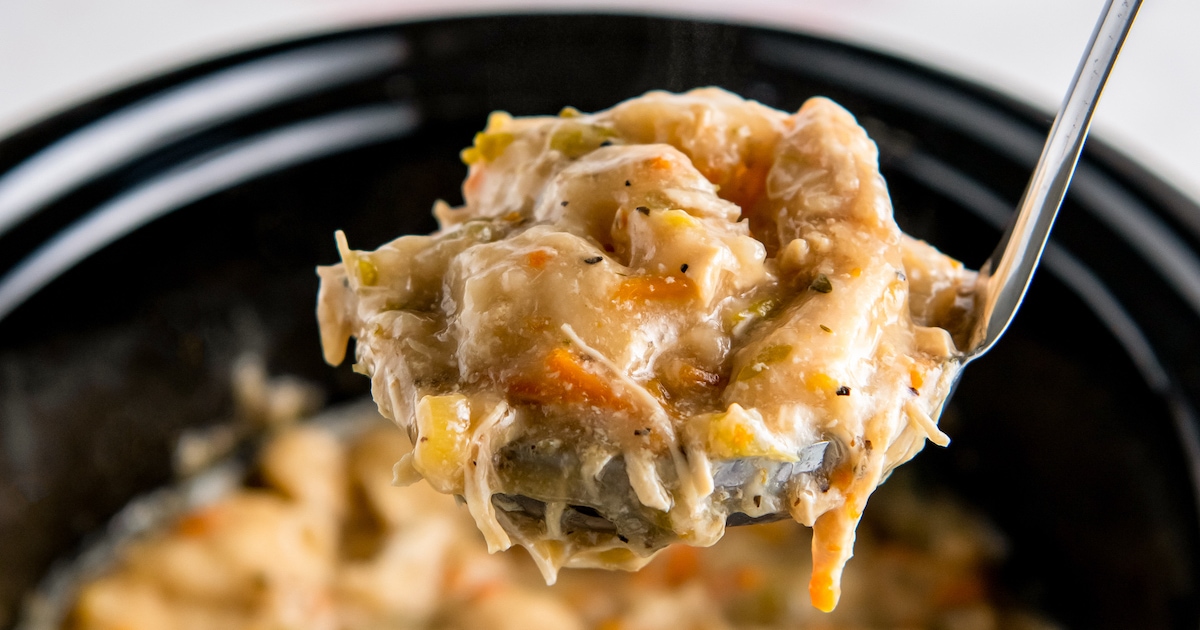 a ladle of chicken and dumplings over a crockpot
