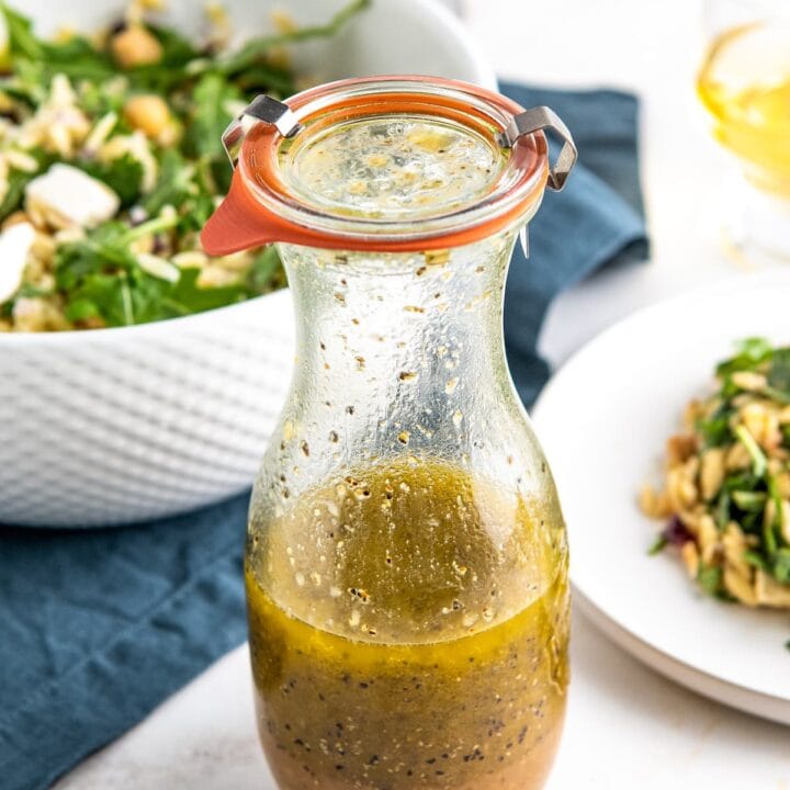 a glass bottle of homemade orange salad dressing
