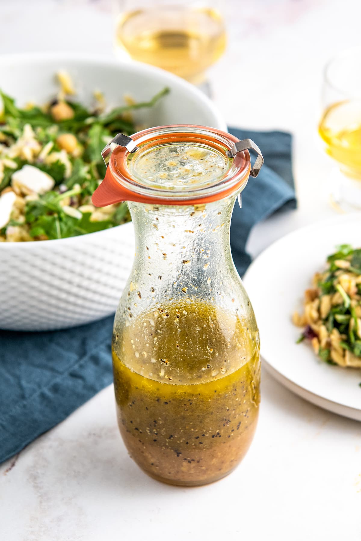 a glass bottle of homemade orange salad dressing