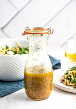 a glass bottle of homemade orange salad dressing