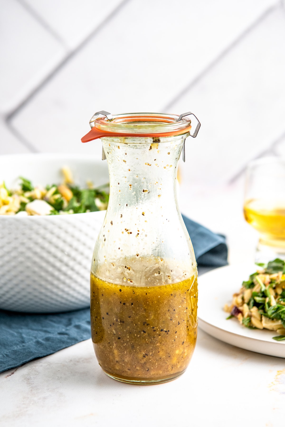 a glass bottle of homemade orange salad dressing