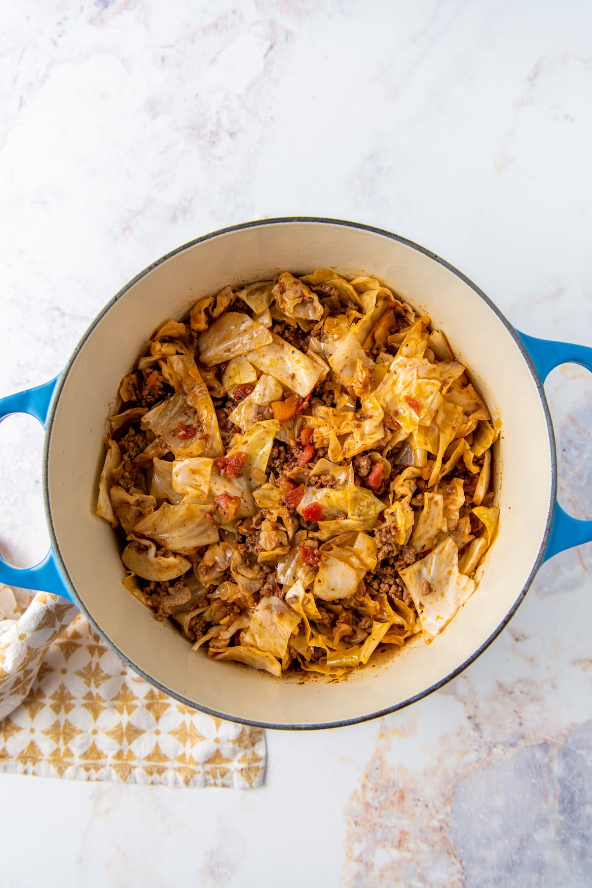 lazy cabbage roll dish in a large pot with cabbage, ground beef, tomatoes, and tomato sauce