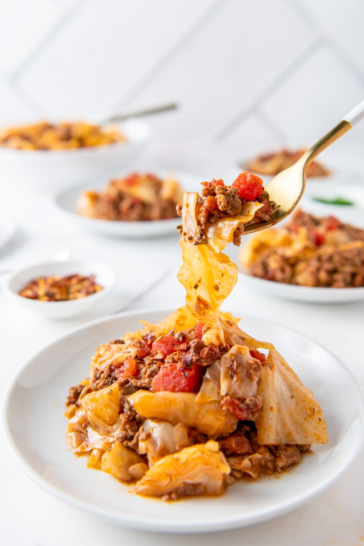 a plate of unstuffed cabbage rolls made with cabbage, beef, and tomatoes