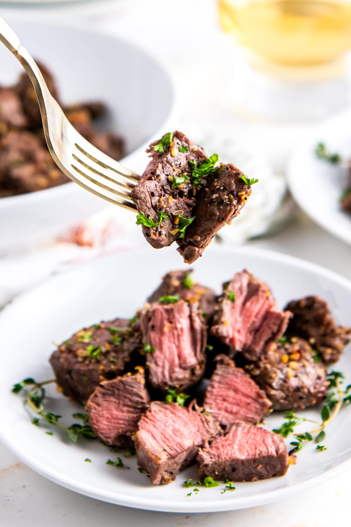 seasoned air fryer steak bites that have been cut in half and are cooked medium