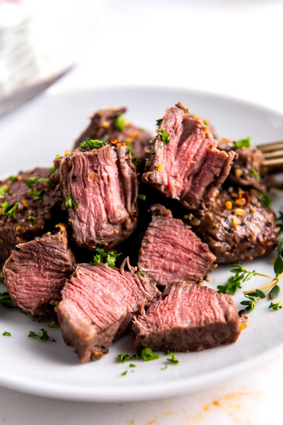 seasoned air fryer steak bites that have been cut in half and are cooked medium