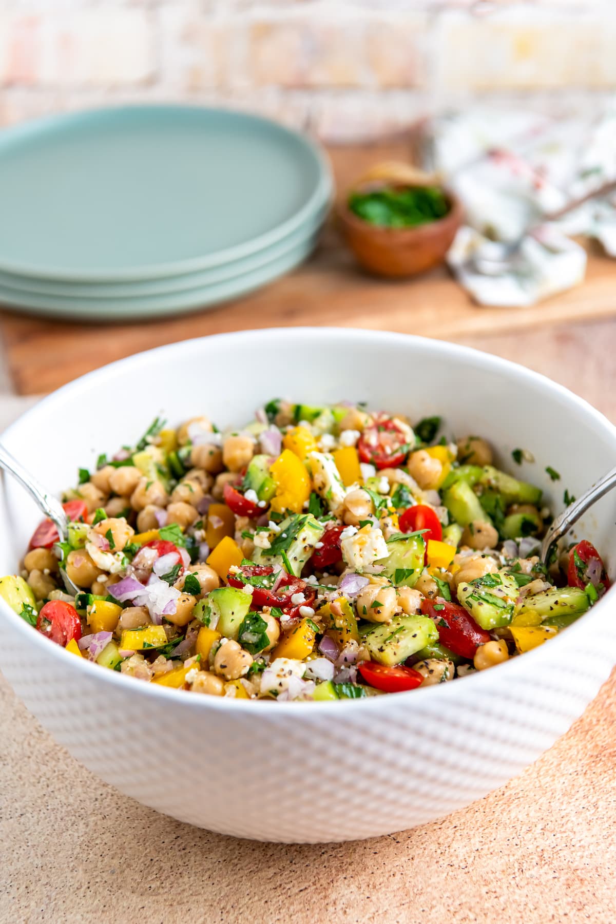 a bowl of chickpea salad with vegetables and herbs