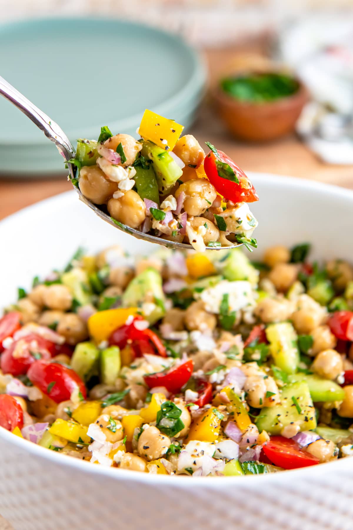 a bowl of chickpea salad with vegetables and herbs