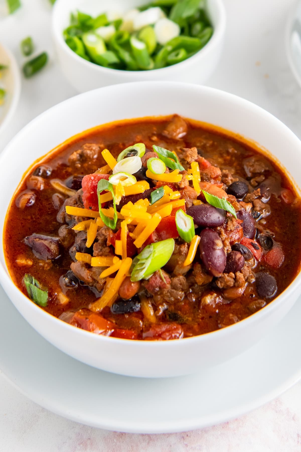 a bowl of crockpot chili with cheese on top