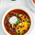bowl of chili with cheese and sour cream on top