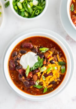 bowl of chili with cheese and sour cream on top