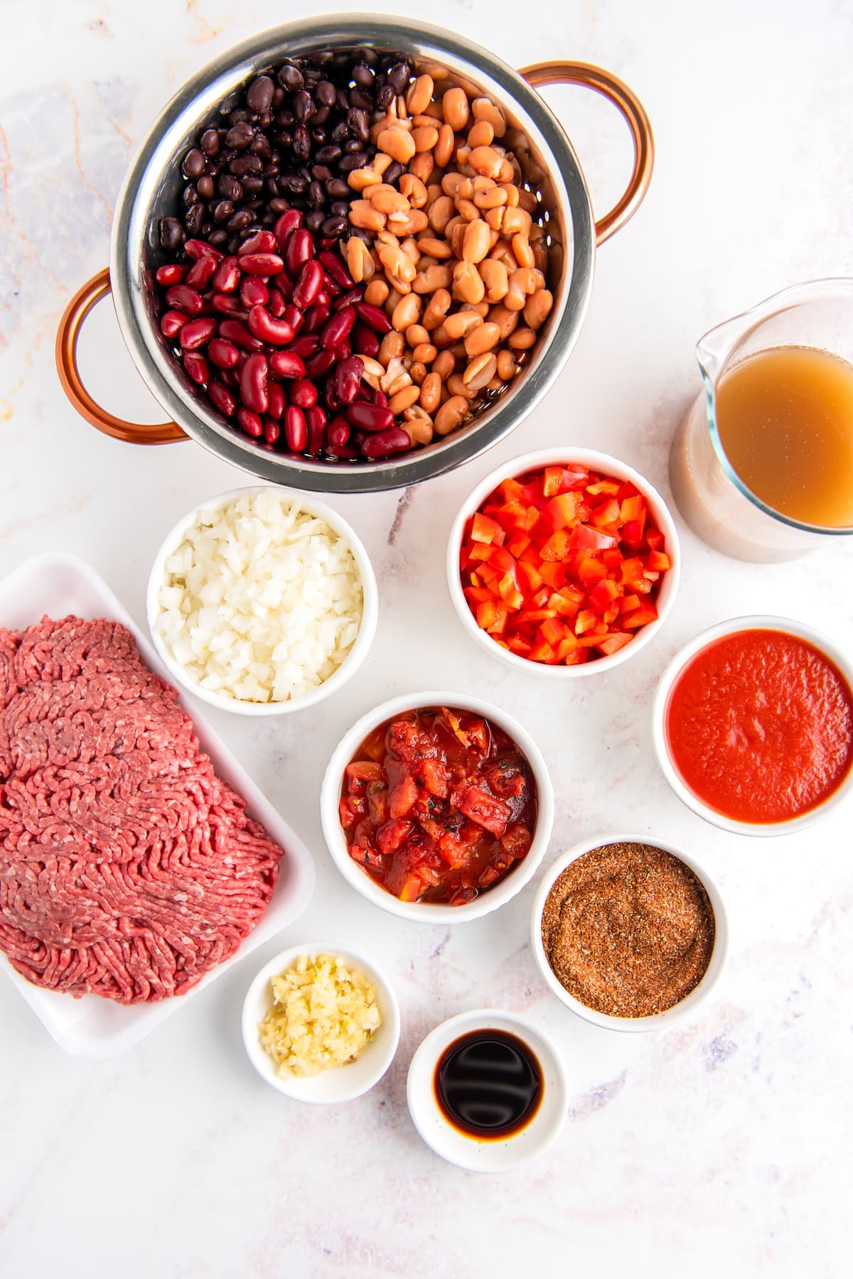 ingredients to make crockpot chili like beans, beef, and spices