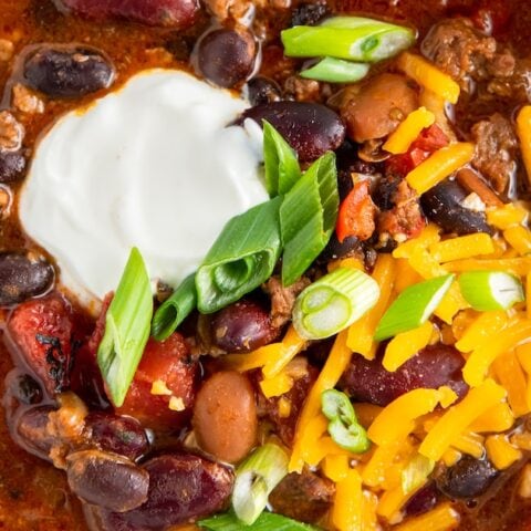 bowl of chili with cheese and sour cream on top