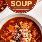 A bowl of pasta fagioli with grated parmesan cheese on top.